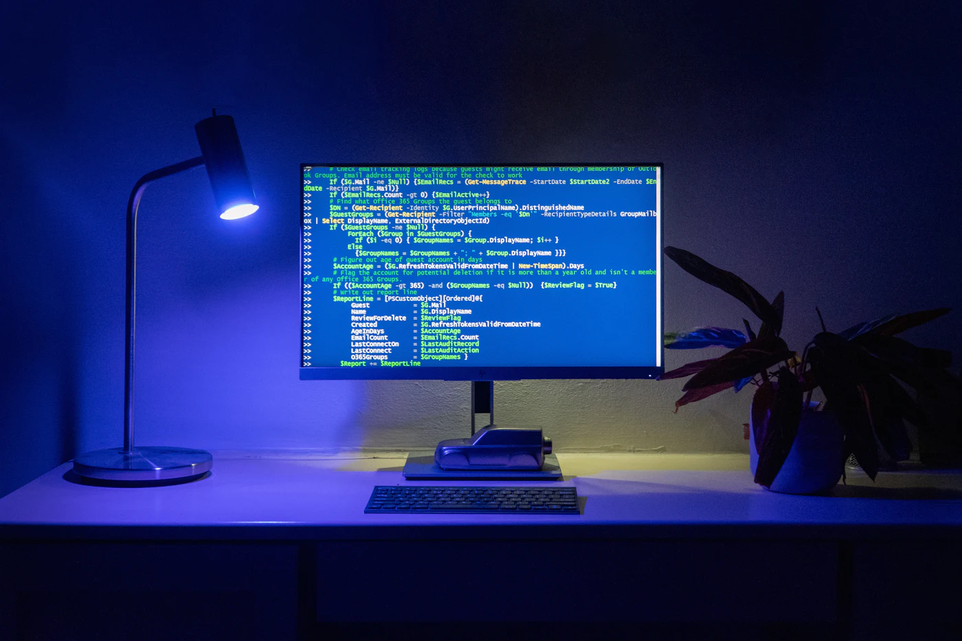 A monitor showing code in a dimly lit room